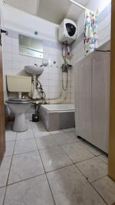 Un baño con inodoro, lavabo y bañera. en Colentina Residence, en Bucarest