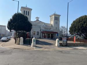 a large white building on the corner of a street at The Mowbray in Eastbourne