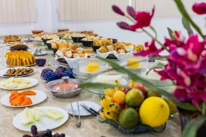 a buffet of food on a table with plates of food at Pousada Paraiso in Guanambi
