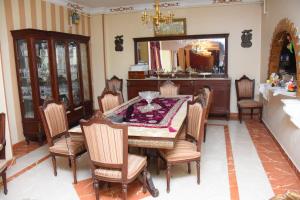 a dining room with a table and chairs and a mirror at Kenzy guest house in Cairo