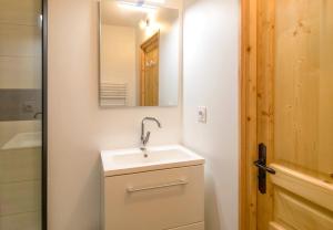 a bathroom with a sink and a mirror at A 4, découverte de la montagne - 80m des pistes in Val Louron