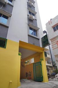 ein Gebäude mit einer gelben und grünen Tür vorne in der Unterkunft Hotel Yellow Bells in Hyderabad