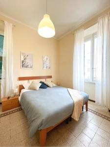 a bedroom with a large bed and a large window at Domus Lido in Lido di Ostia