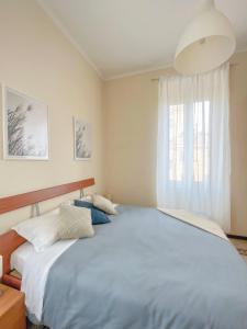 a bedroom with a large bed and a window at Domus Lido in Lido di Ostia