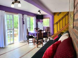 a living room with a couch and a table at CABAÑA LA MILAGROS REINA MORA in Merlo