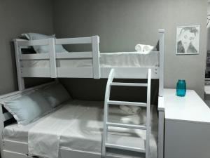 a bedroom with two bunk beds with a ladder at LukasSaloMea in Borjomi