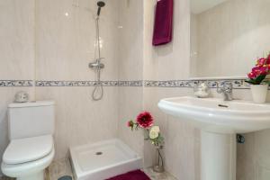 a bathroom with a toilet and a sink at MalagaSuite Torremolinos Lovely & Comfy in Torremolinos +18 photos