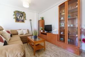 a living room with a couch and a tv at MalagaSuite Torremolinos Lovely & Comfy in Torremolinos +22 photos