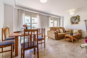 a living room with a table and a couch at MalagaSuite Torremolinos Lovely & Comfy in Torremolinos