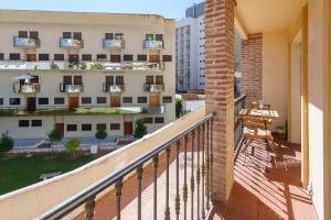 a balcony with a view of a building at MalagaSuite Torremolinos Lovely & Comfy in Torremolinos