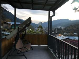 a balcony with a bench and a view of a city at LukasSaloMea in Borjomi