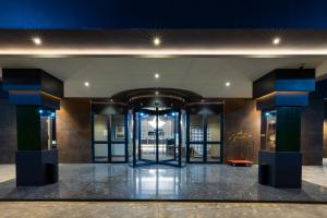 a lobby with glass doors in a building at AZ Hotels Grand Oran in Oran