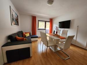 a living room with a table and a dining room at Apartments Irena in Bohinj
