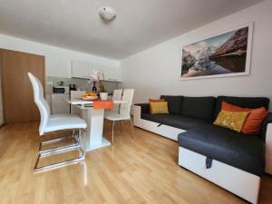 a small living room with a couch and a table at Apartments Irena in Bohinj