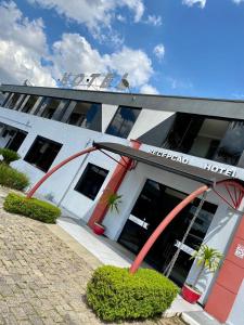a large white building with a hotel at SuiteCase in Curitiba