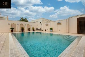 a swimming pool in the middle of a building at LUX VILLA with amazing BBQ, Pool Area & WIFI by 360 Estates in Is-Swieqi