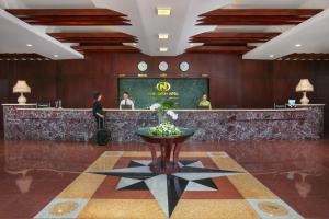 a lobby of a hotel with a counter with clocks at Nam Cuong Hai Duong Hotel in Hải Dương