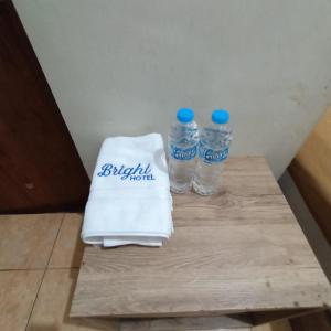 two bottles of water sitting on a table at NamRoom at Tangki Lio in Jakarta