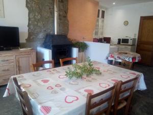 a dining room with a table and a fireplace at Château Villemagne in Lagrasse