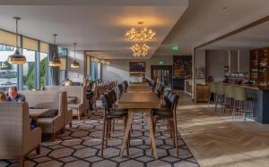 a dining room filled with tables and chairs at Carlton Hotel Dublin Airport in Cloghran