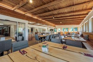 Landgasthof Allerberger في فالس: غرفة طعام مع طاولات وكراسي خشبية