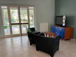a living room with two chairs and a television at Ostello Fiume Tirino in Bussi sul Tirino