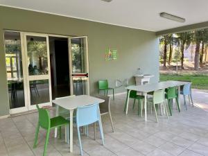 a group of tables and chairs in a patio at Ostello Fiume Tirino in Bussi sul Tirino