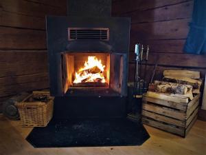 a fireplace with a fire in it in a room at Hammarstrand Budget Hotell- Lergodset in Hammarstrand