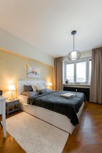 a bedroom with a large bed and a window at Old Town Vintage Apartment Sturova in Košice