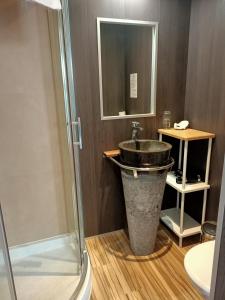 a bathroom with a sink and a shower at Hotel Saint Amant in Le Palais