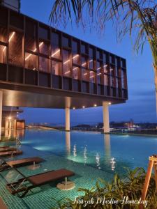 a building with a bridge over a body of water at Bali Residences by Fauzah Muslim Homestay in Melaka