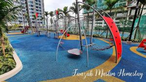 a playground with a slide and a swing at Bali Residences by Fauzah Muslim Homestay in Melaka
