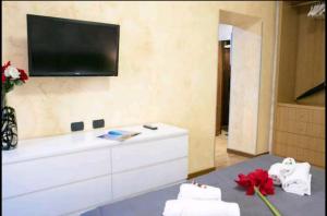 a living room with a tv on the wall at Dulcis In Colosseo Apartments in Rome