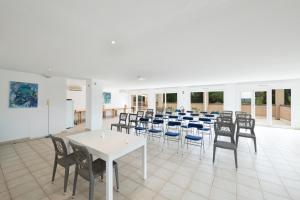 a large room with a table and chairs in it at Garden & City Les Bastides de Grimaud in Grimaud