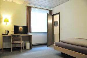 Postel nebo postele na pokoji v ubytování Hotel Garni Haus Dornheim
