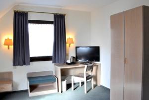 TV a/nebo společenská místnost v ubytování Hotel Garni Haus Dornheim