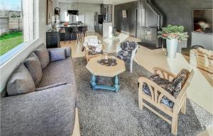 a living room with a couch and a table at Beautiful Home In Moëlan-Sur-Mer in Moëlan-sur-Mer