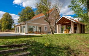 a house with a conservatory on the side of it at Villa Nikšić in Otočac