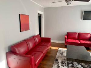 a living room with a red couch and a table at Spanish Town / Downtown Apartment in Baton Rouge