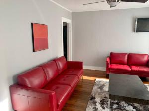 a living room with a red couch and a table at Spanish Town / Downtown Apartment in Baton Rouge +1 photo