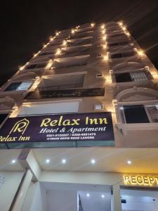 a building with a sign on the side of it at Relax Inn in Lahore