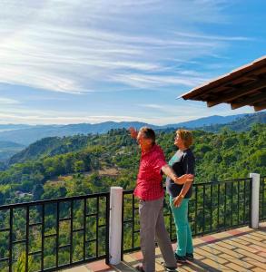 a man and a woman standing on top of a mountain at Hotel Kasama in San Agustín