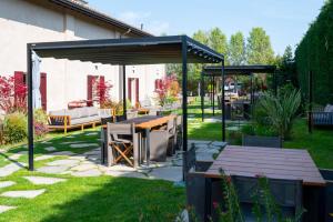 a patio with a wooden table and a pavilion at Atena Dolce Vita in Brescia