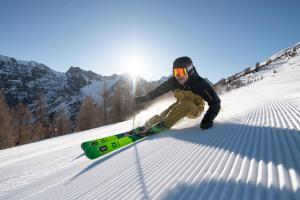 a person is skiing down a snow covered slope at Apartments am Bichl in Fulpmes