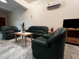 a waiting room with couches and a flat screen tv at Hijauan Studio Unit @ Ocean View Resort in Port Dickson +14 photos