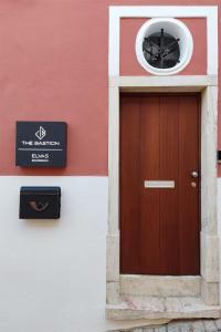 a building with a brown door and a sign on it at The Bastion Elvas Apartments in Elvas
