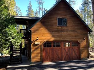 a barn with a garage door and a staircase at Evergreen Lodge at Yosemite in Groveland