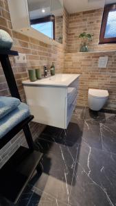 a bathroom with a white sink and a toilet at FP-Immobilien in Harsum