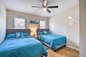 a bedroom with two beds and a ceiling fan at Baltimore Townhome Near Oriole Park with AandC! in Baltimore
