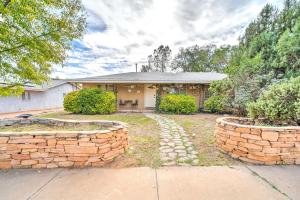 a house with a brick wall and a driveway at Colorful Cottonwood Escape with Mountain View! in Cottonwood